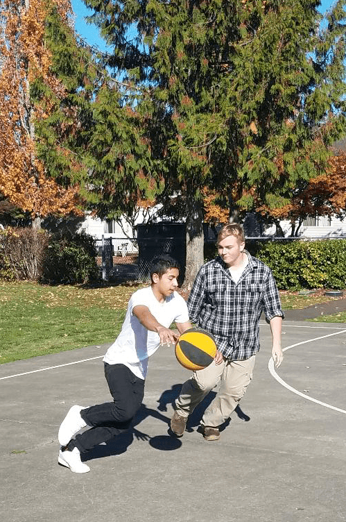 Students at Flex playing basketball outside
